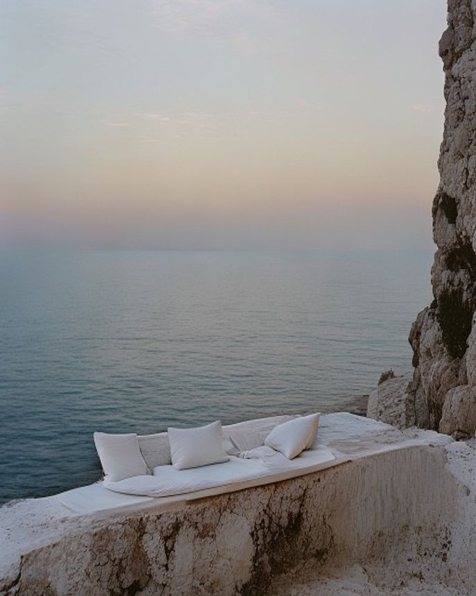 Whitewashed villa on a Greek island cliff